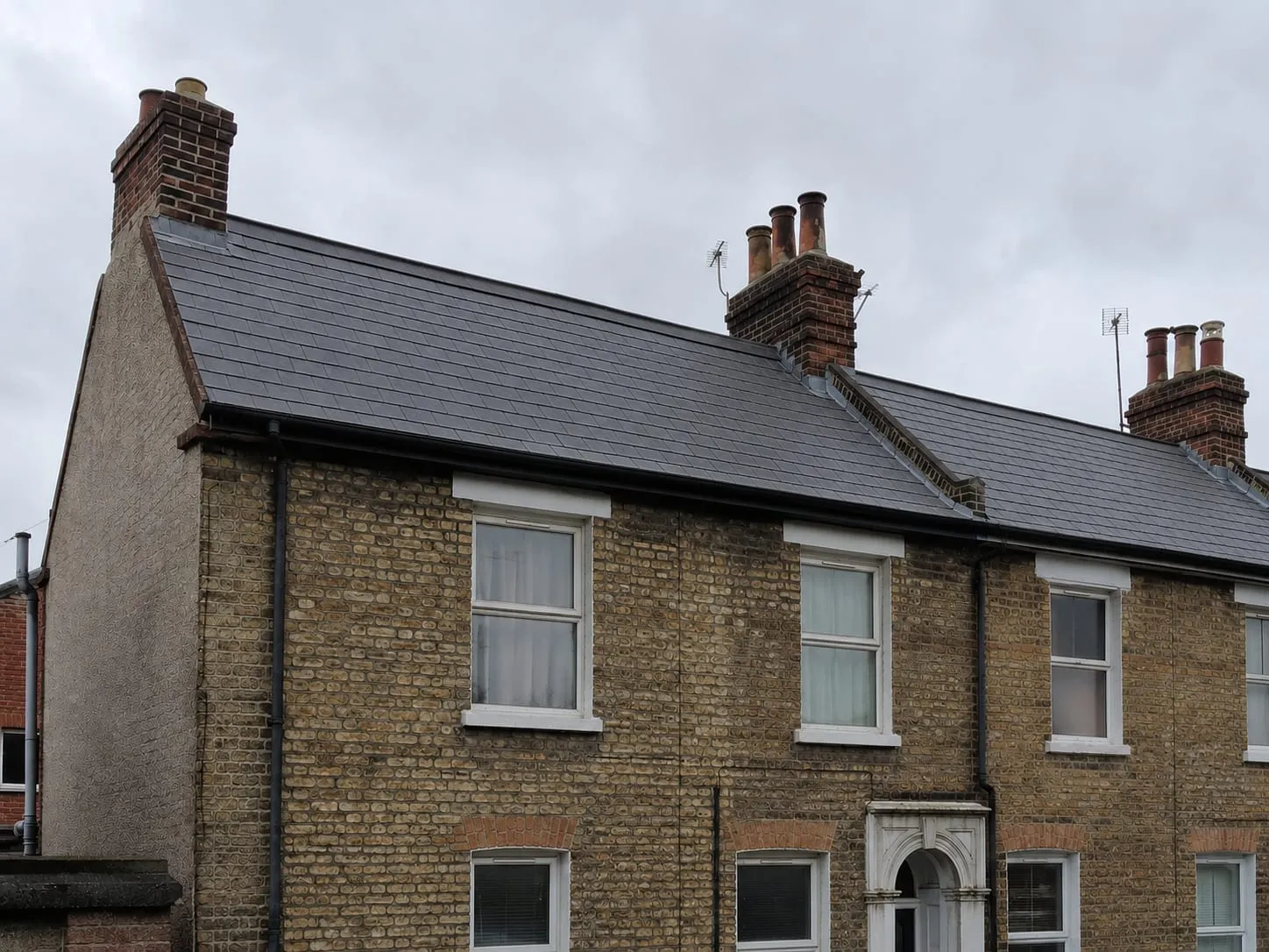 The same brick terrace after a full re-roof in crisp new natural slate